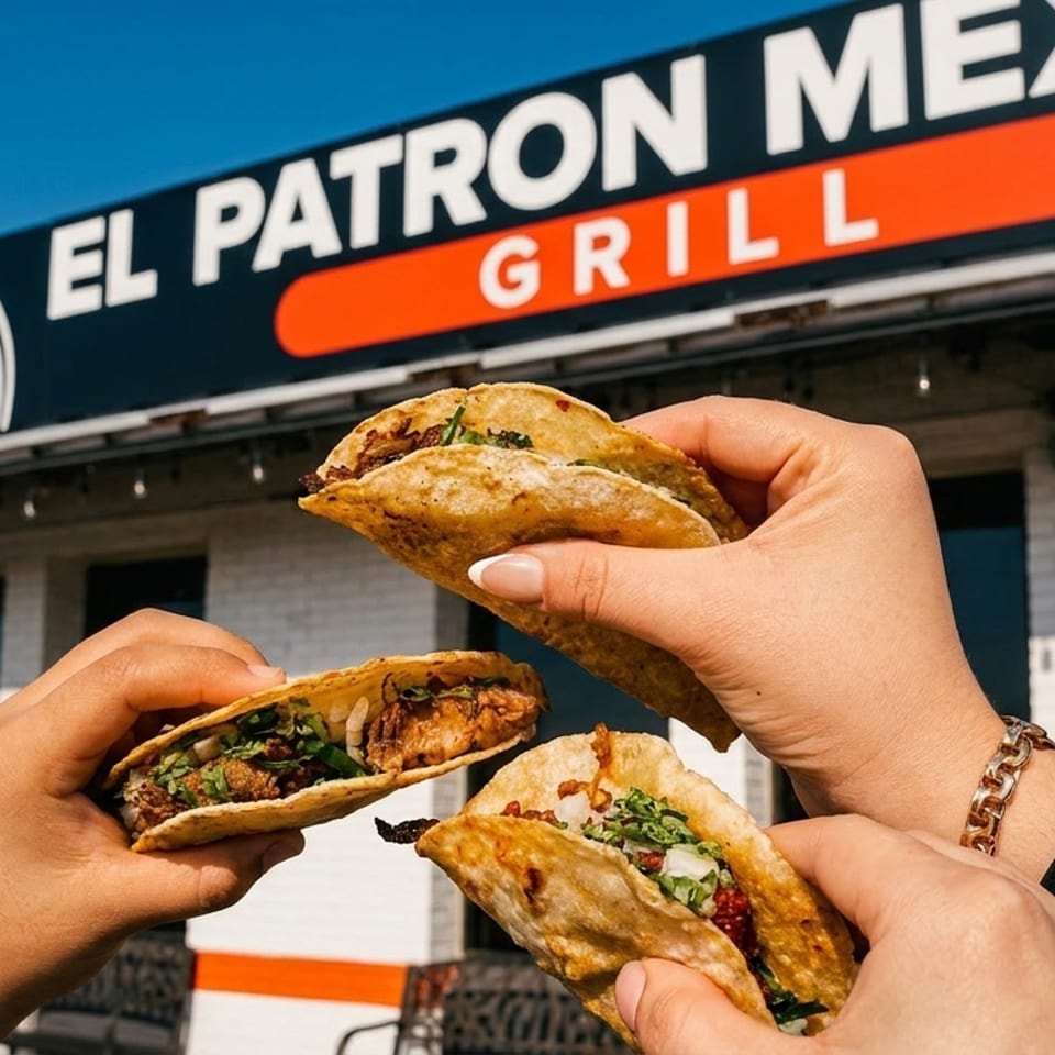 Three hands hold up tacos filled with meat and cilantro in front of the El Patron Mexican Grill sign.